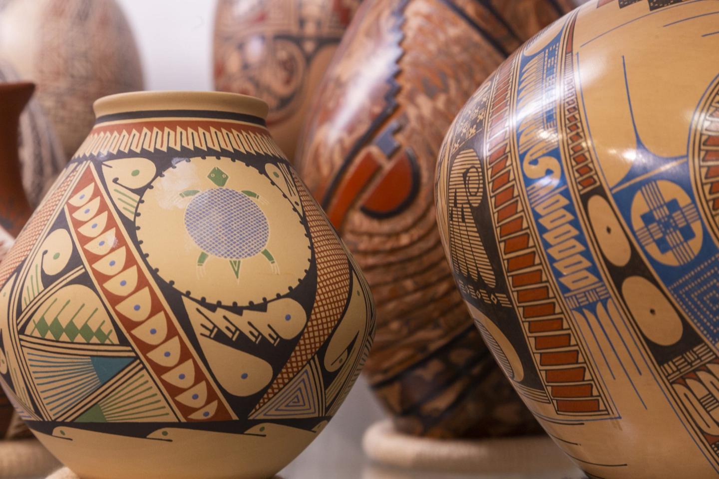 Ornate clay pots with intricate, colorful patterns.