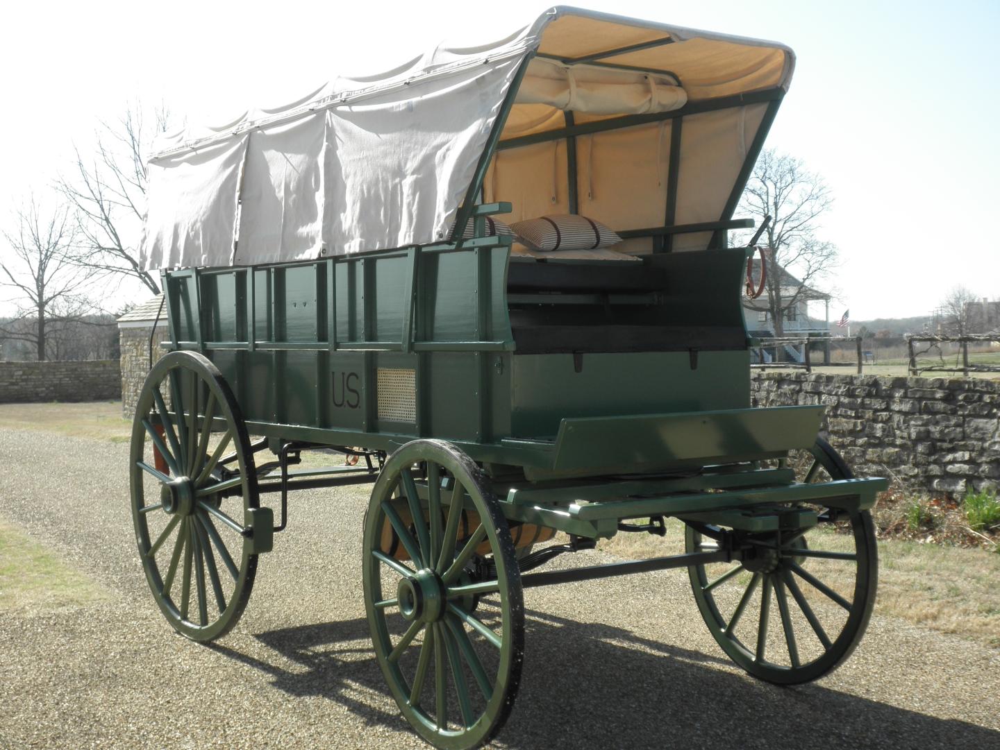 Civil war ambulance with white canopy on a sunny day.