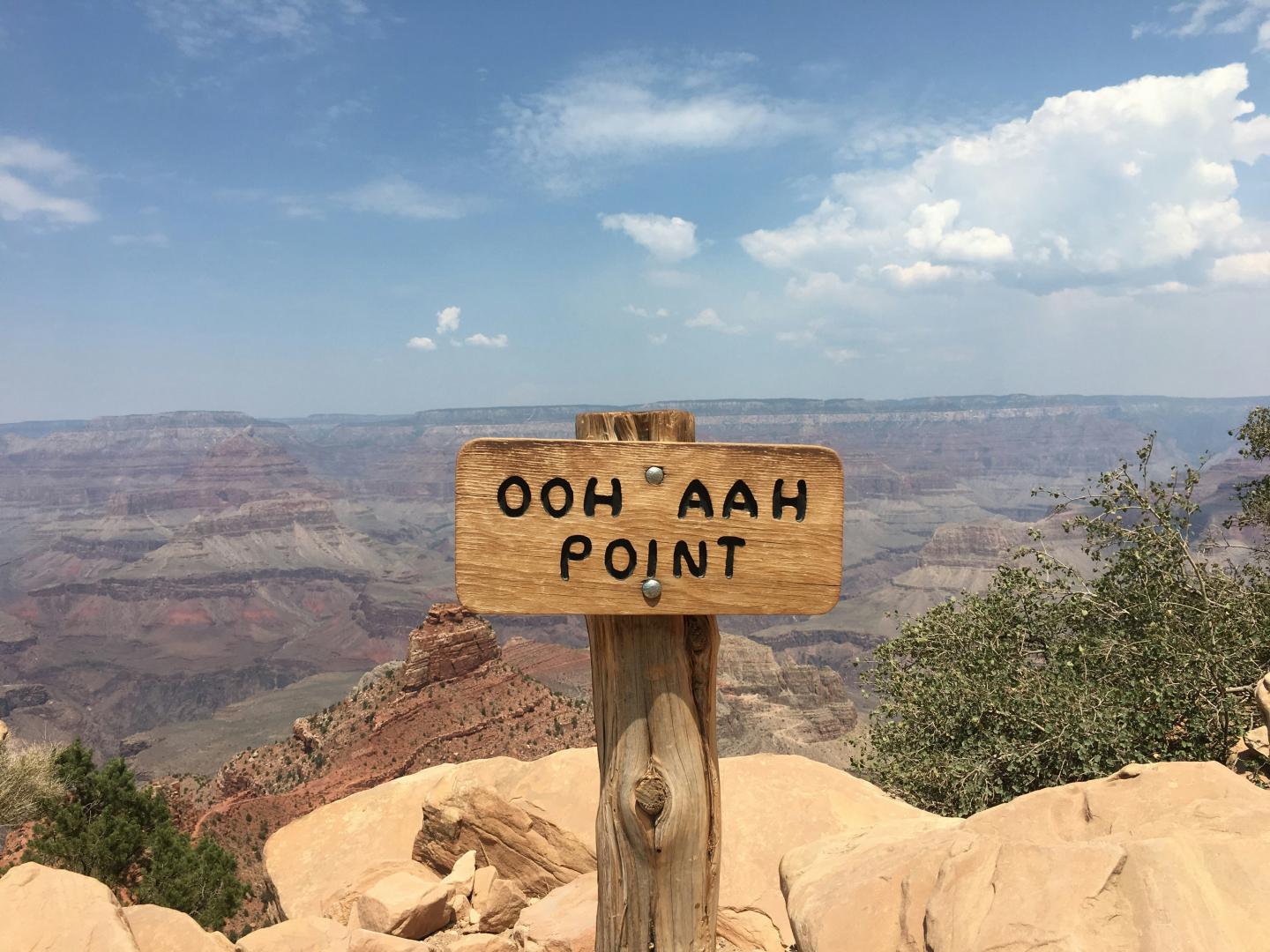 Wooden sign reading "Ooh Aah Point" overlooking the Grand Canyon.