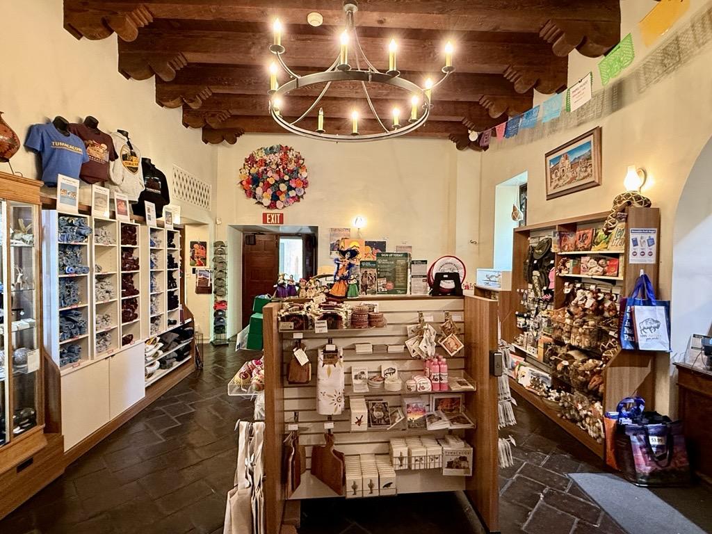 Cozy park store at Tumacacori National Historical Park with wooden beams, colorful decor, and well-stocked shelves.