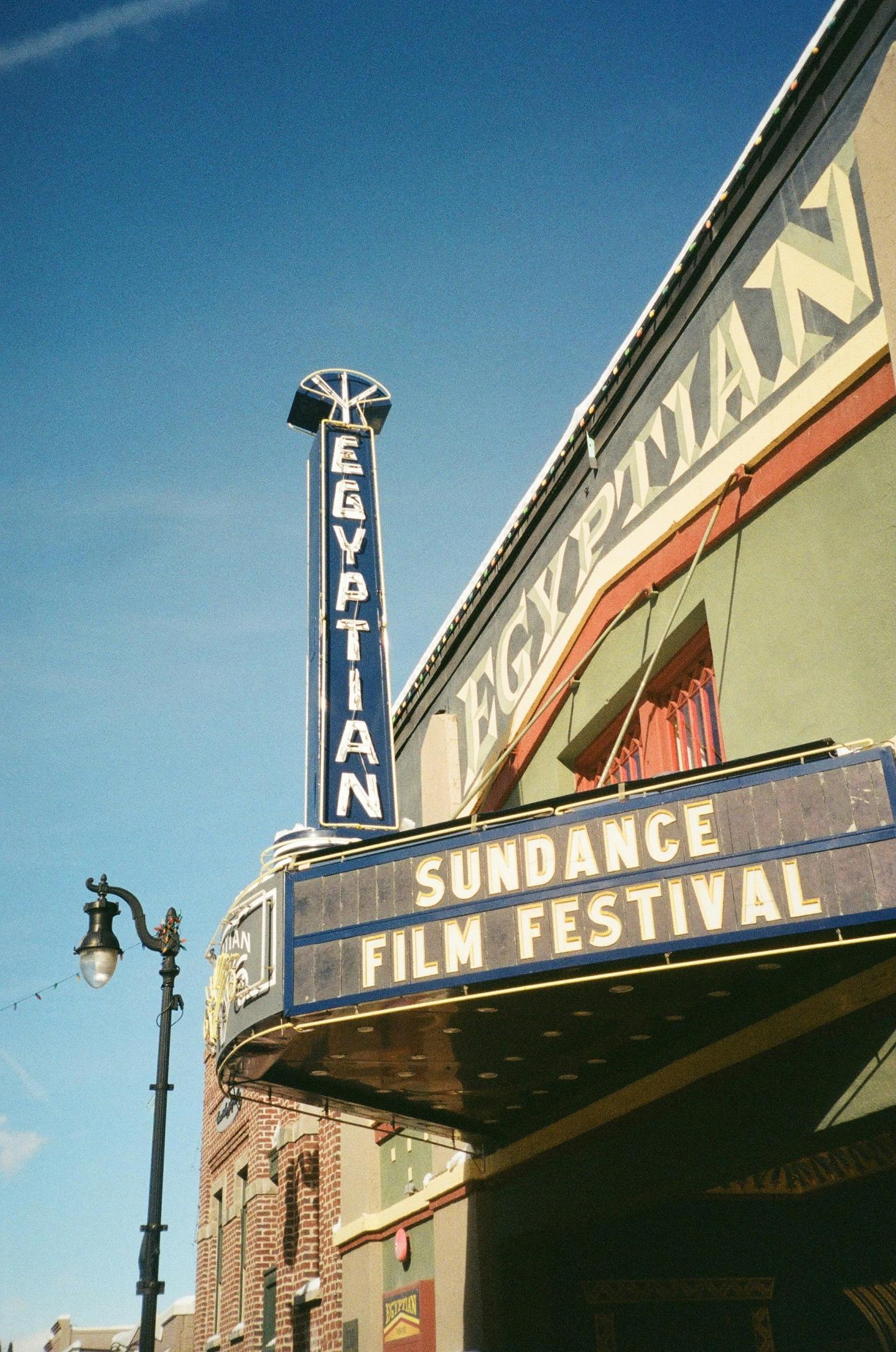Egyptian Theatre with Sundance Film Festival sign under clear blue sky.