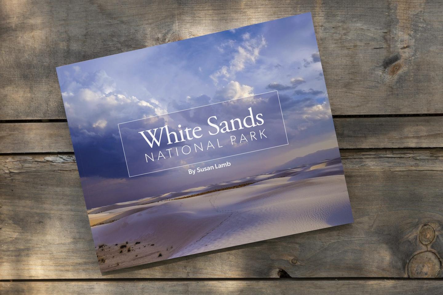 Brochure for White Sands National Park on wooden surface.