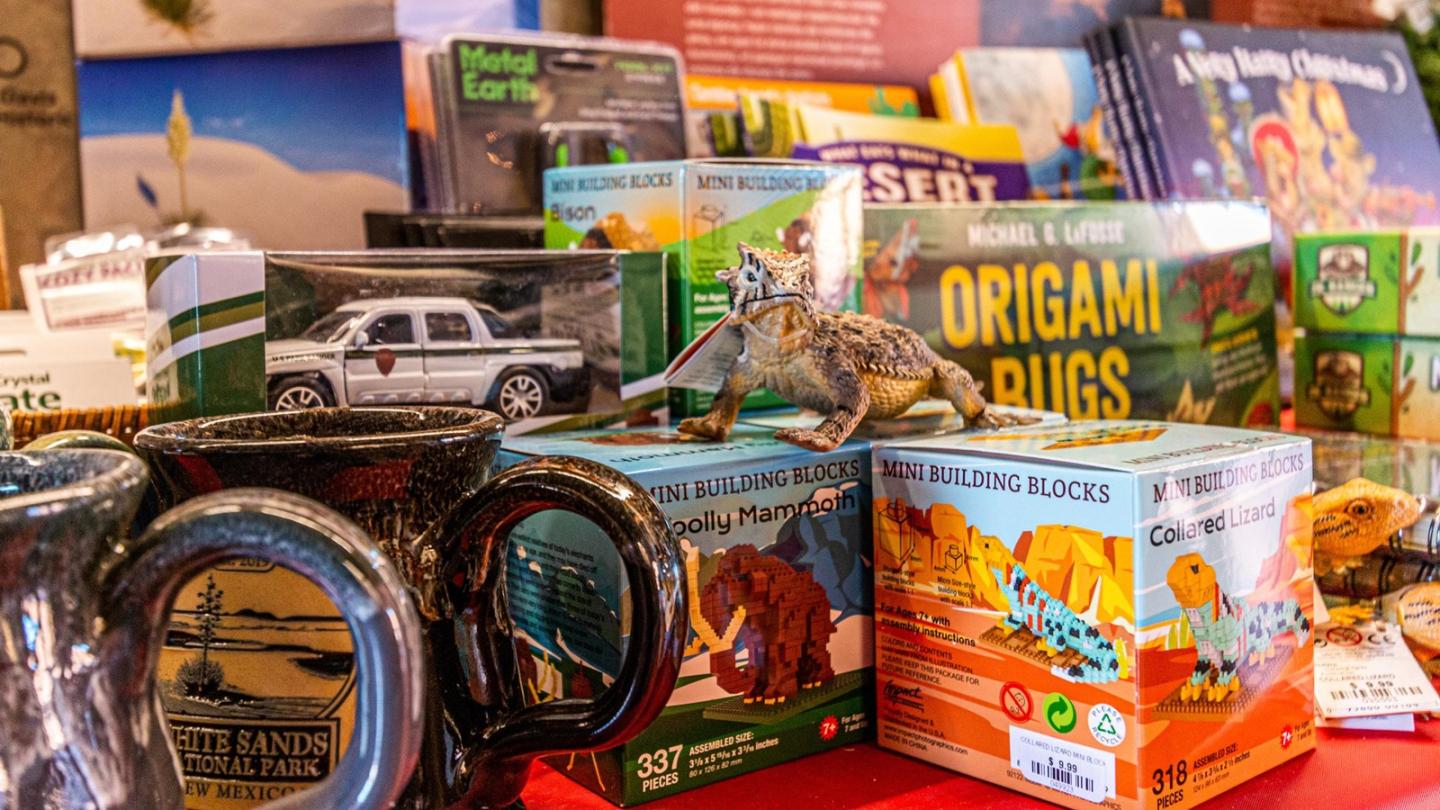 White Sands National Park Western National Parks Park Store Board games, puzzles, and mugs arranged on a table, with colorful boxes.
